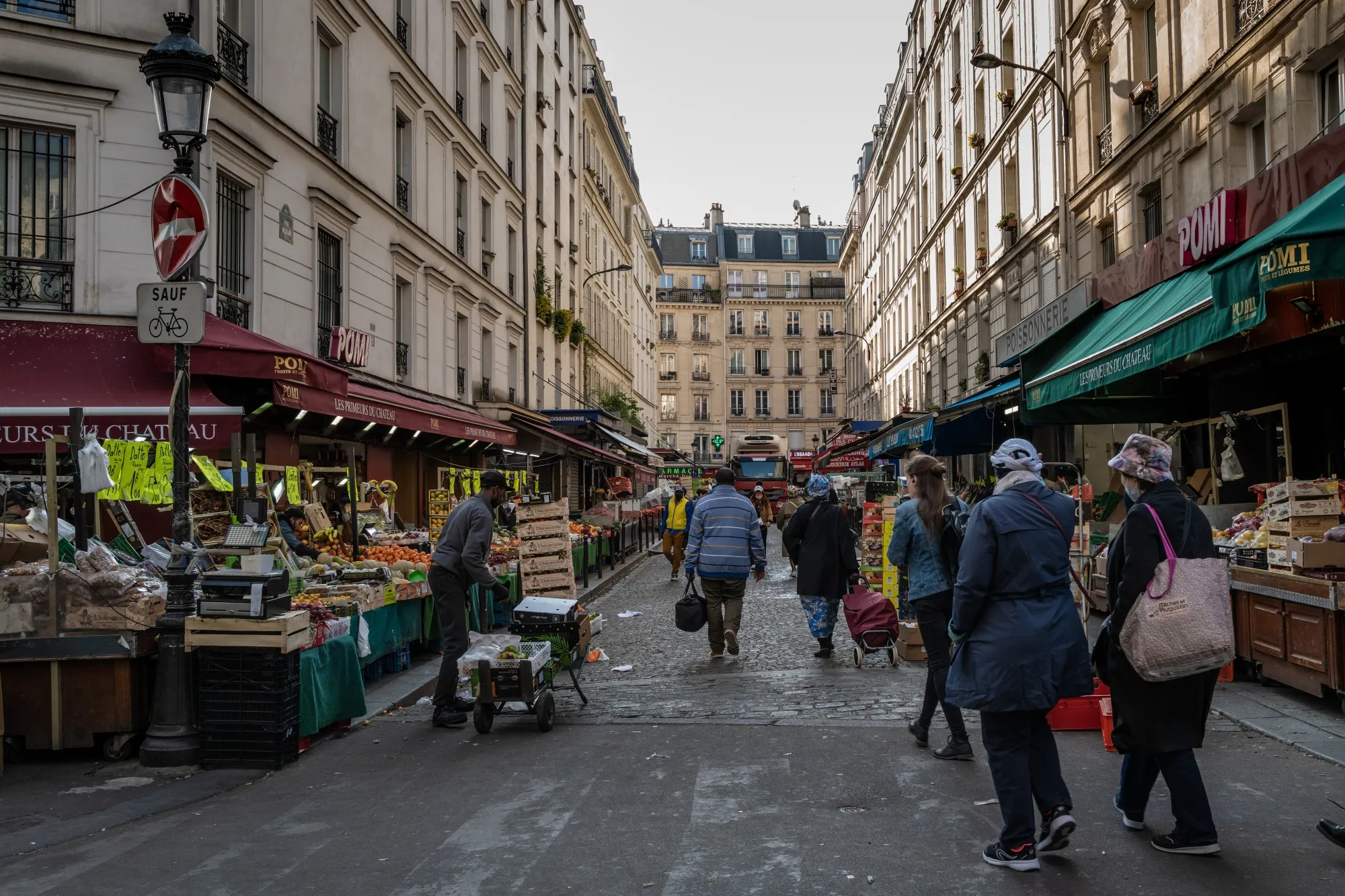 Shoppers visit the Chateau Rouge Exotique market in the 18th arrondissement of Paris, France.