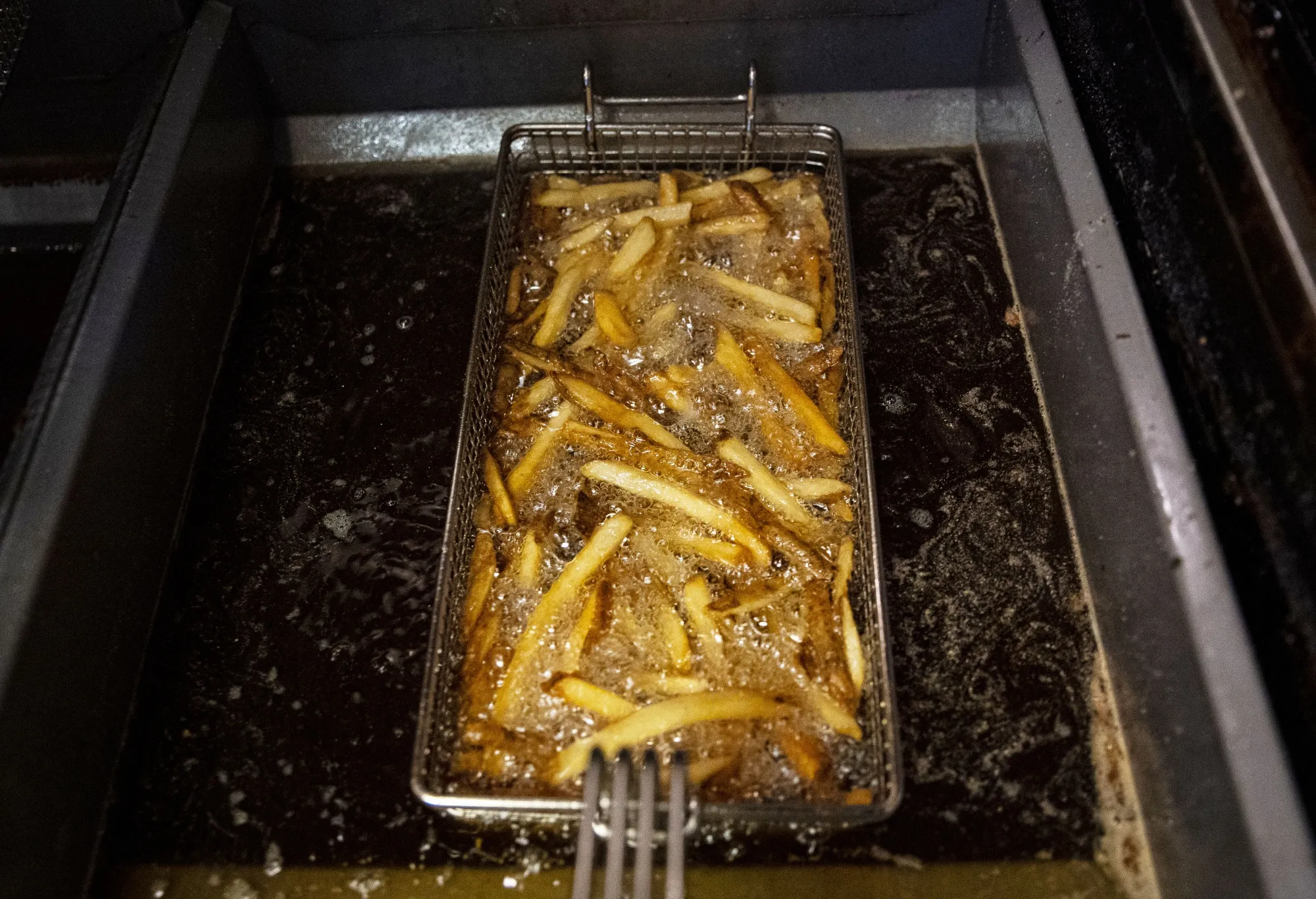 French fries cook in a deep fryer at a tavern in Washington.