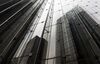 Buildings are reflected on the side of the Mizuho Financial Group Inc. headquarters in Tokyo, Japan, on Friday, April 21, 2017. Mizuho is scheduled to release full-year earnings figures on May 15.