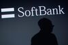 The shadow of Ken Miyauchi, executive vice president at SoftBank Corp. and chief executive officer of SoftBank's mobile unit, is cast against a screen displaying the company's logo during a product launch in Tokyo, Japan, on Tuesday, May 19, 2015. SoftBank's Japanese mobile business added a net 1.8 million subscribers in the year ended March bringing the total to 37.77 million, the company reported last week.