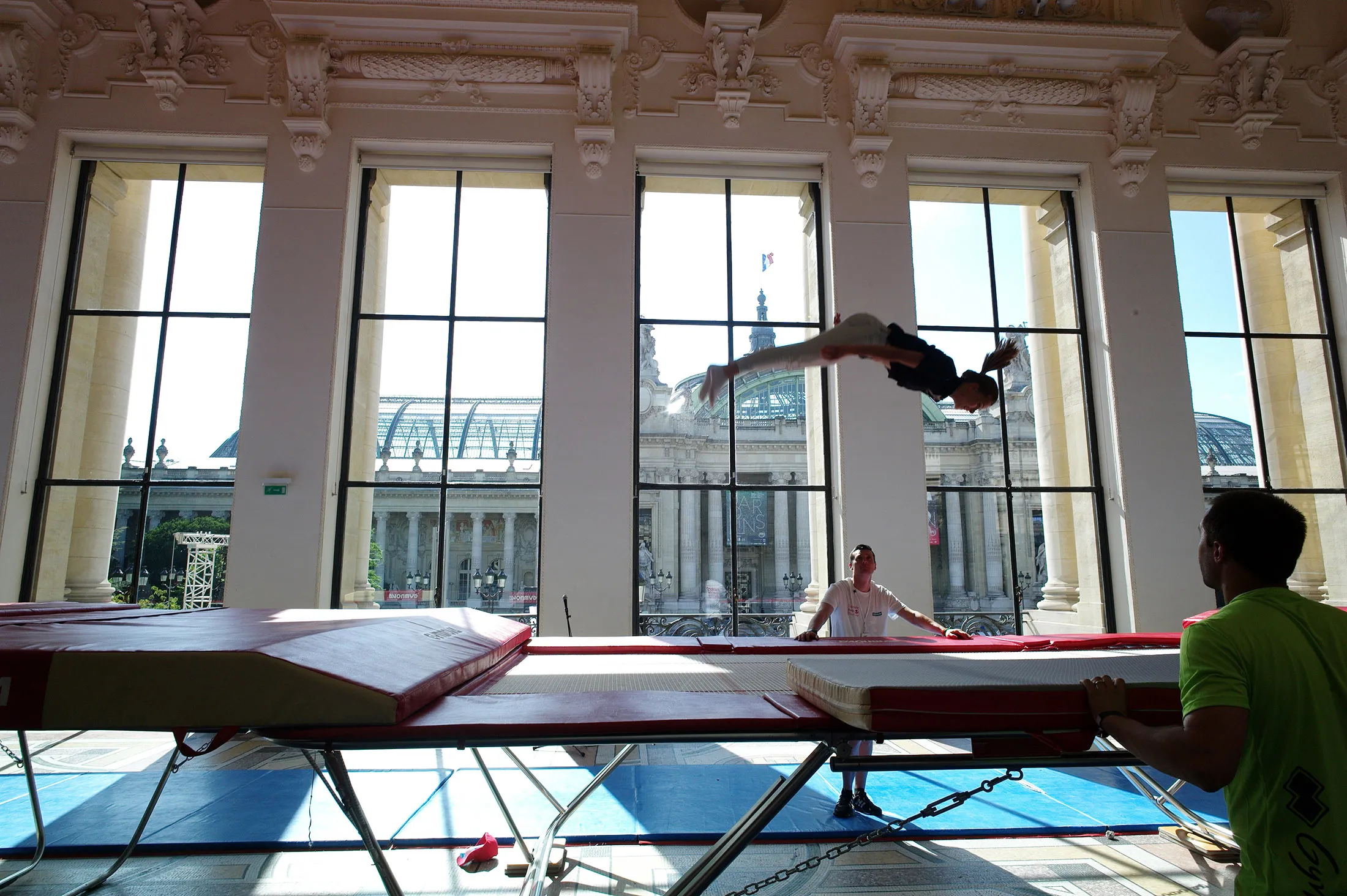 A gymnast performs on a trampoline at the Petit Palais in Paris.
