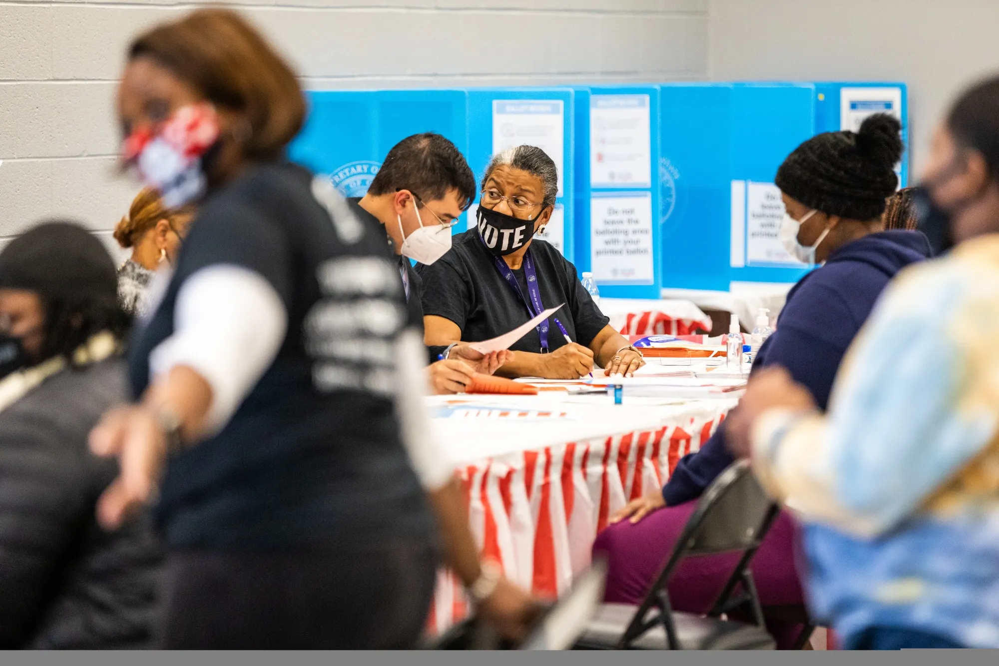 Election officials assist voters at a polling location during the Senate runoff elections in Atlanta on Jan. 5, 2021.&nbsp;
