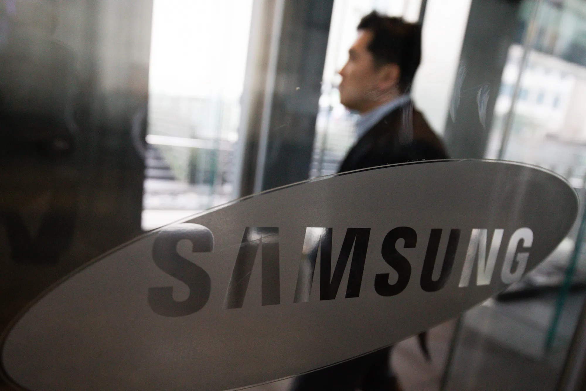 The Samsung Electronics Co. logo is displayed on glass doors at the company's Seocho office building in Seoul, South Korea.
