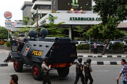 A police armored vehicle stands near the site of an explosion in Jakarta.
