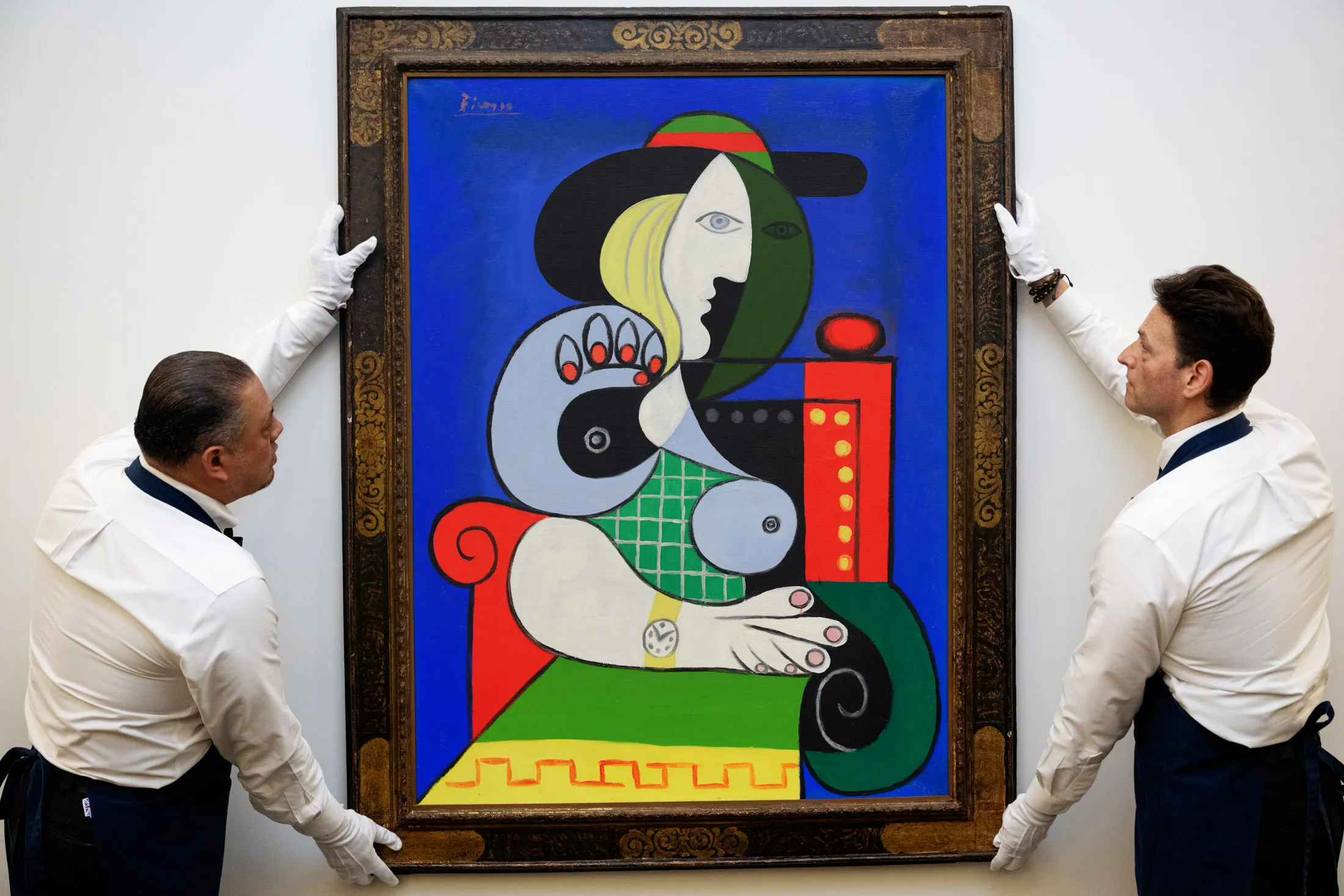 Sotheby’s art handlers adjust Pablo Picasso’s Femme à la montre,&nbsp;from the Emily Fisher Landau Collection. It’s expected to sell in excess of&nbsp;$120 million.