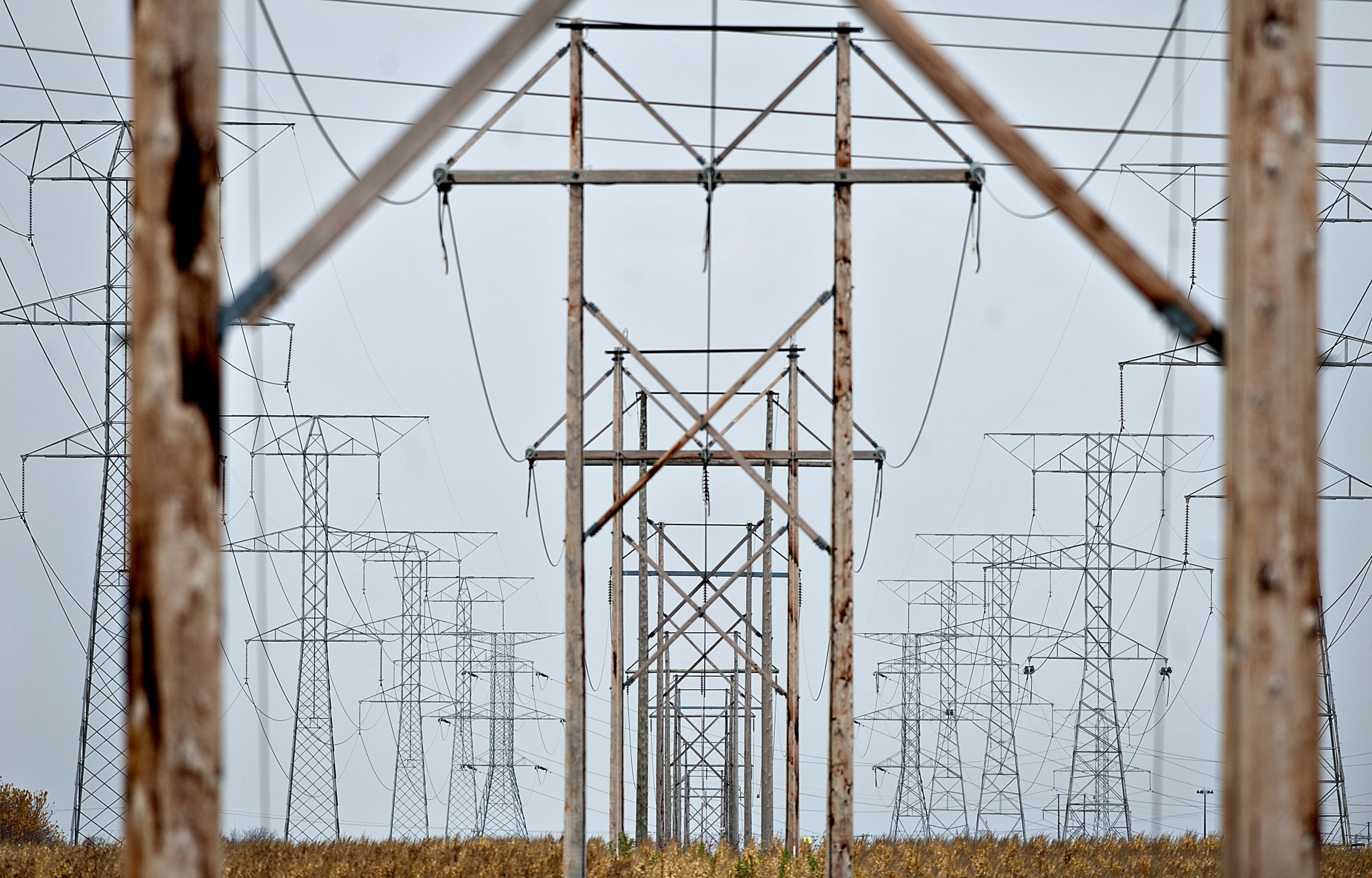 Electrical lines hang from transmission towers near the natural gas fired 1200-megawatt Kendall Energy power plant, owned by Dynegy Inc., in Minooka, Illinois, U.S., on Sunday, Nov. 6, 2011.