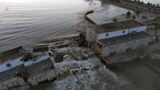Water flows strongly through a breakthrough in the Kakhovka dam in Kakhovka, Ukraine, Tuesday, June 6, 2023. While both Ukraine and Russia oficials accused each other of destroying the Nova Kakhovka dam in the Russian-controlled part of the Kherson region