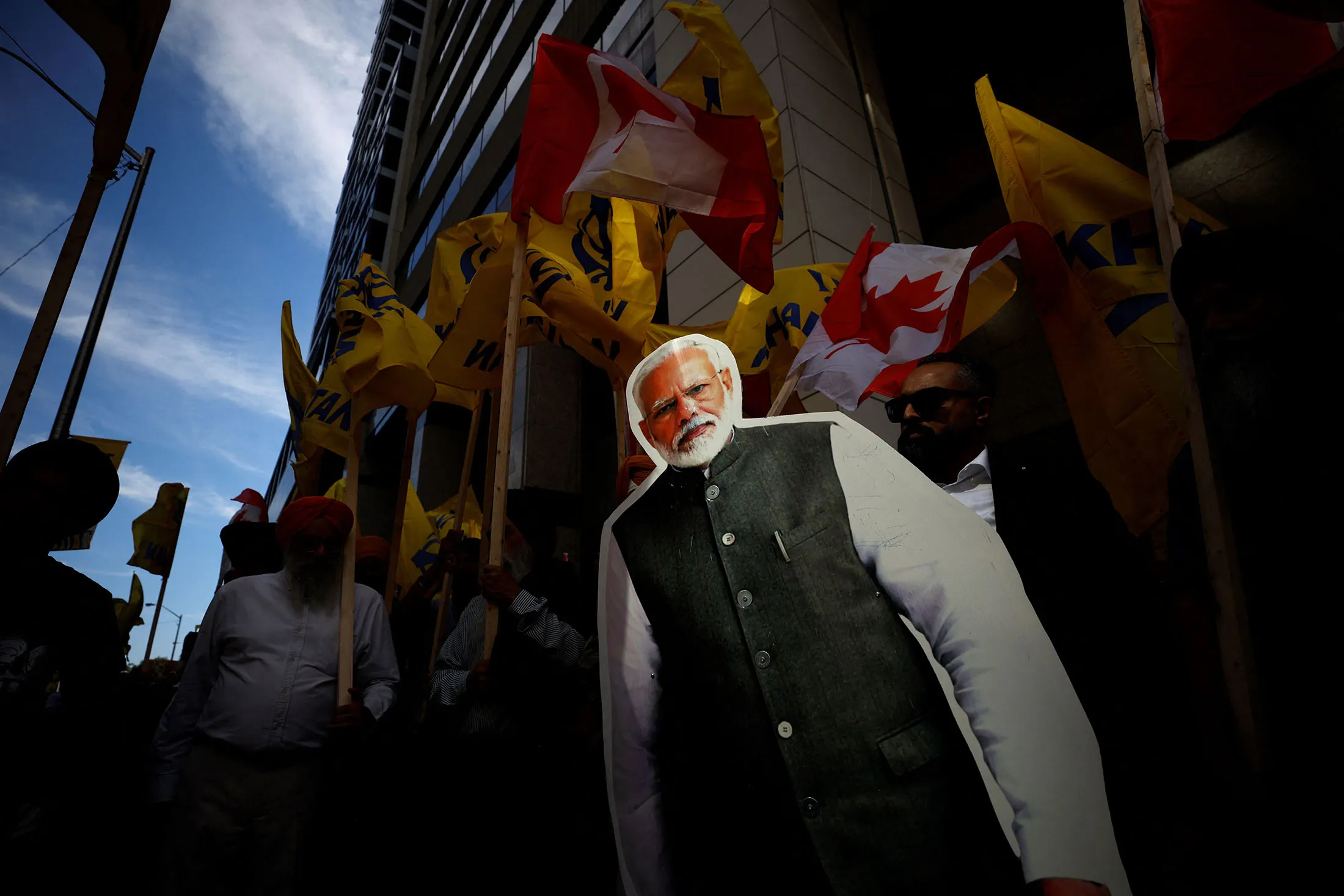 People hold a cutout depicting Indian prime minister Narendra Modi during a Sikh rally outside the Indian consulate a in Toronto.