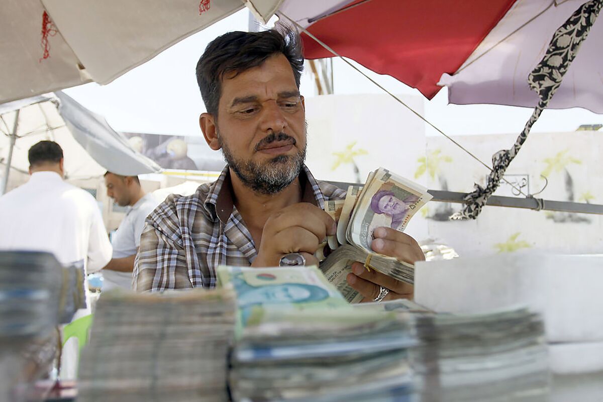Iraq is devaluing its currency by a record as the economy unleashes