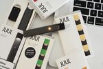 A Juul Labs Inc. e-cigarette, USB charger and flavored pods.