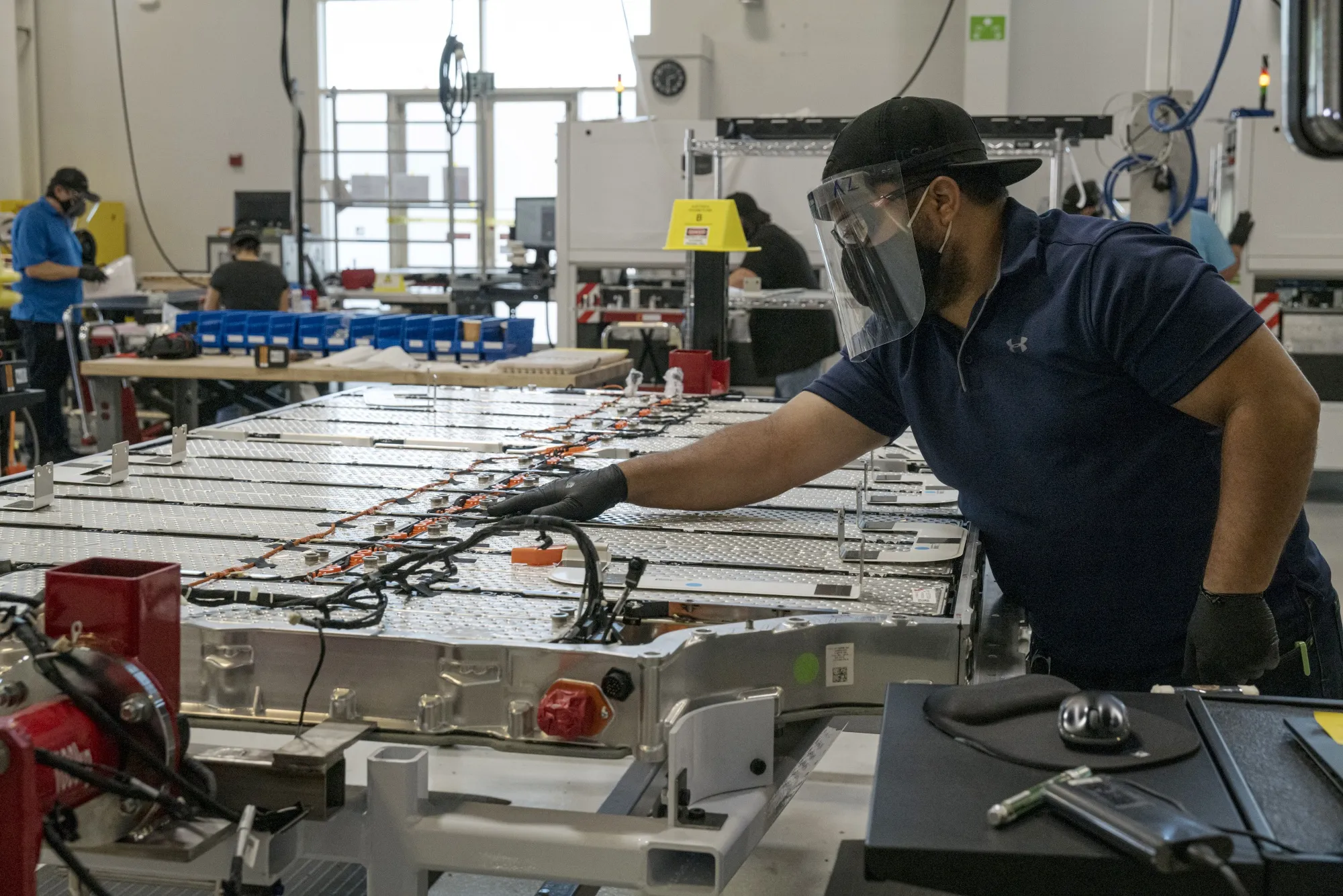 A worker checking&nbsp;a Lucid Air battery pack at the company's headquarters in Newark, California.