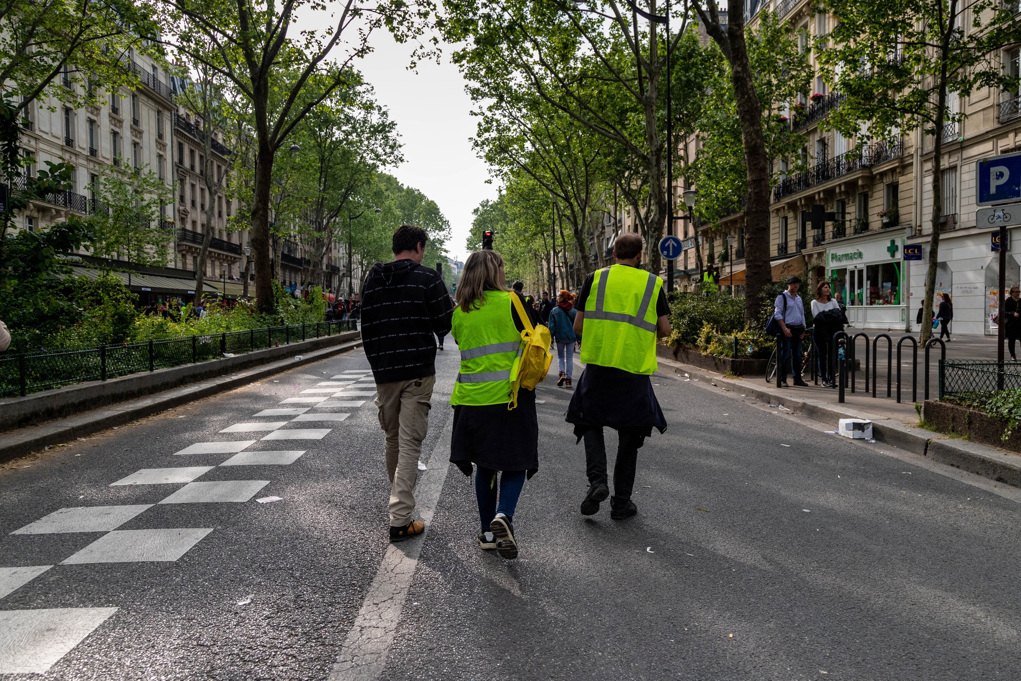 Yellow vest protesters walk along an avenue after protesting during International Workers' Day in Paris, France, on Wednesday, May 1, 2019. French President Emmanuel Macron has called for an extremely firm response to violent protesters at Wednesday's traditional May 1 holiday demonstrations.
