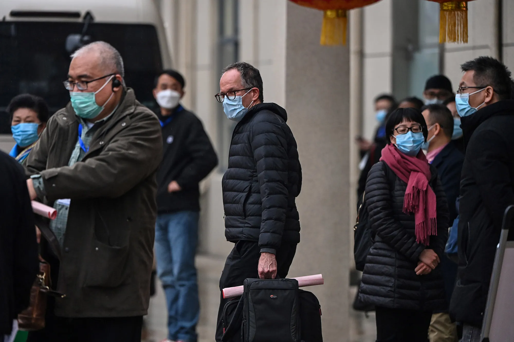 Scientists&nbsp;with the World Health Organization&nbsp;leave&nbsp;after visiting the Jiangxinyuan community centre in Wuhan, in Feb.&nbsp;