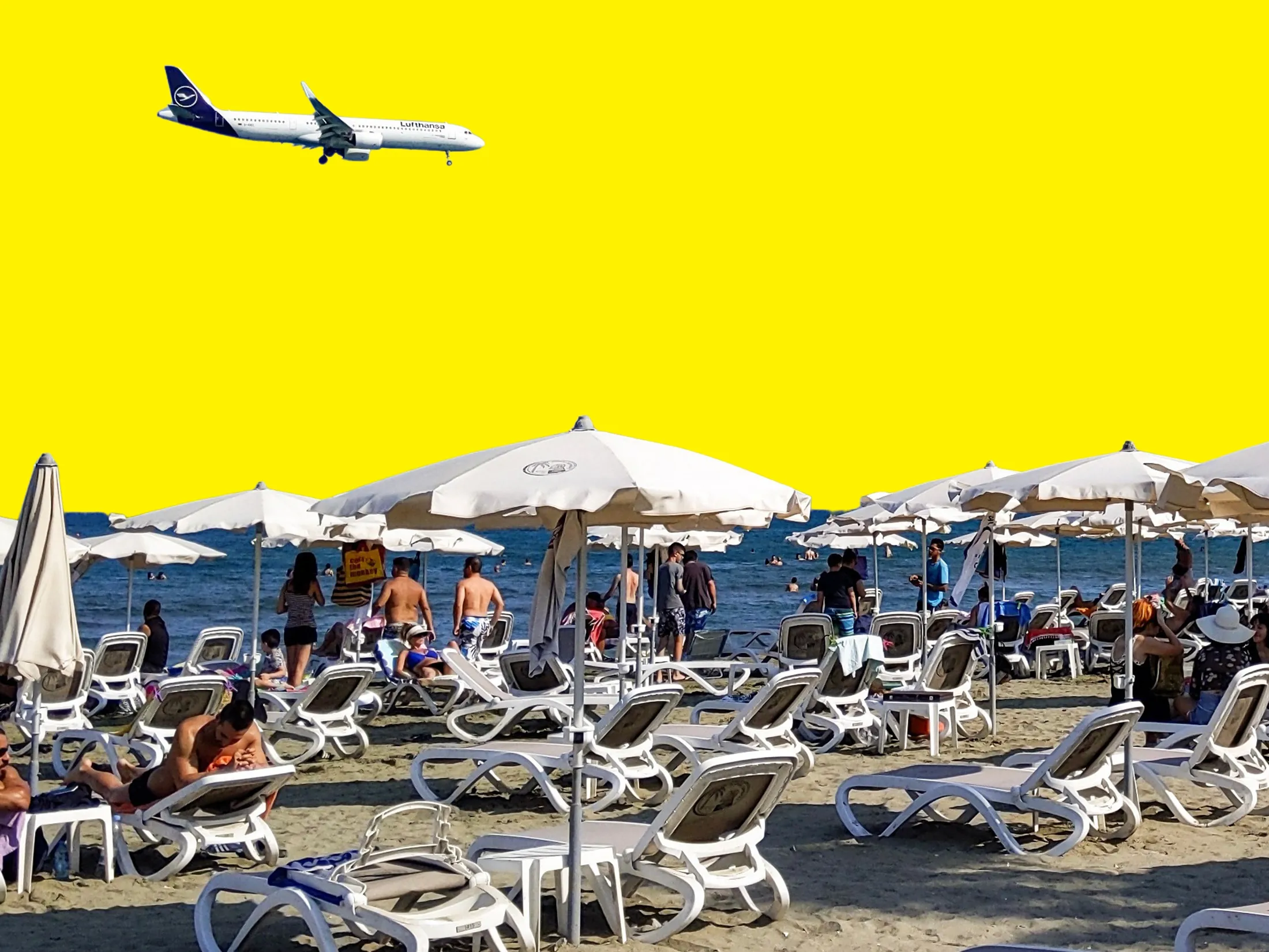 A Lufthansa Airbus A321neo aircraft flies over beachgoers on its descent approach towards Cyprus’ Larnaca International Airport.