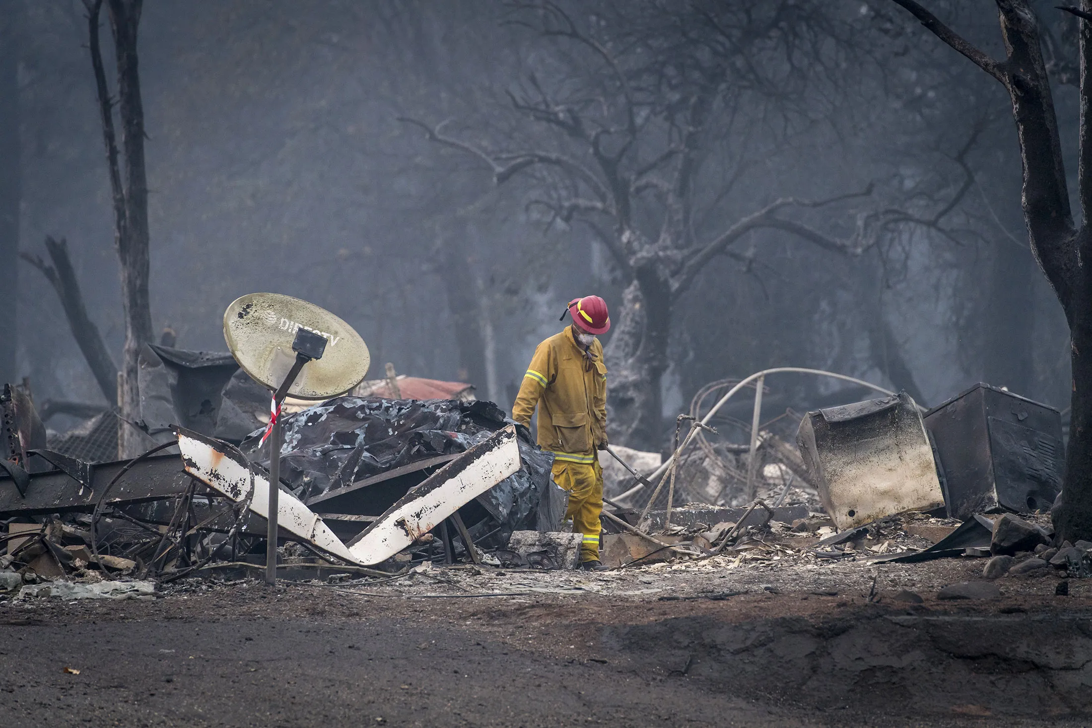 A firefighter searches a burned-out building in Paradise, California, on&nbsp;Nov. 15, 2018.