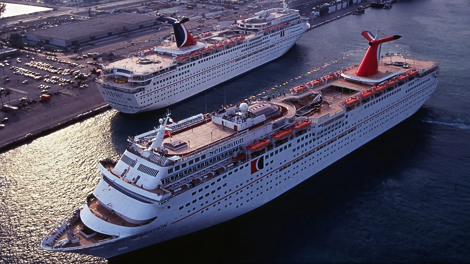 Carnival Cruise Lines' Sensation, foreground, passes by its sistership Ecstasy at the Port of Miami in this undated file photo. On Saturday, September 3, 2005 Carnival announced that Sensation, Ecstasy and the Holiday, another Carnival ship, would be pulled from regular cruise service for six months and chartered to the Federal Emergency Management Agency to provide temporary housing for Hurricane Katrina victims. The Ecstasy and Sensation are to base in Galveston, Texas, while Holiday is to port in Mobile, Alabama.
