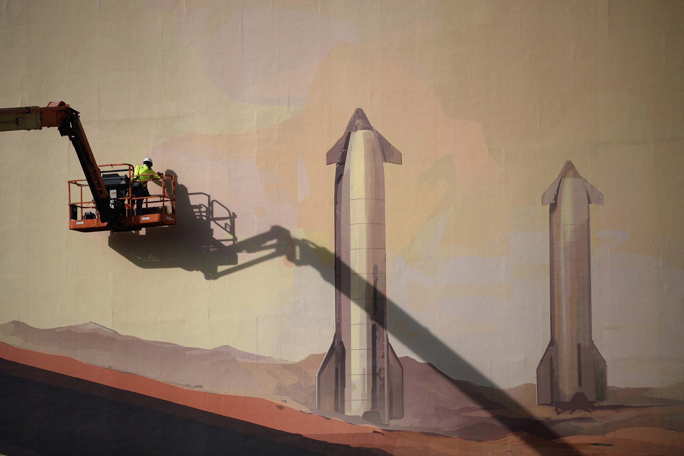 A mural outside of the SpaceX Starbase industrial complex and rocket launch facility depicting rockets on Mars in Boca Chica, Texas, US, on Thursday, April 17, 2025. Residents of the tiny community near SpaceX's rocket launch site voted on May 3 to officially incorporate the area as its own city, Starbase, Texas. Photographer: Mark Felix/Bloomberg