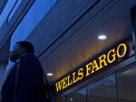 A pedestrian walks past a Wells Fargo & Co. bank branch in Washington, D.C.