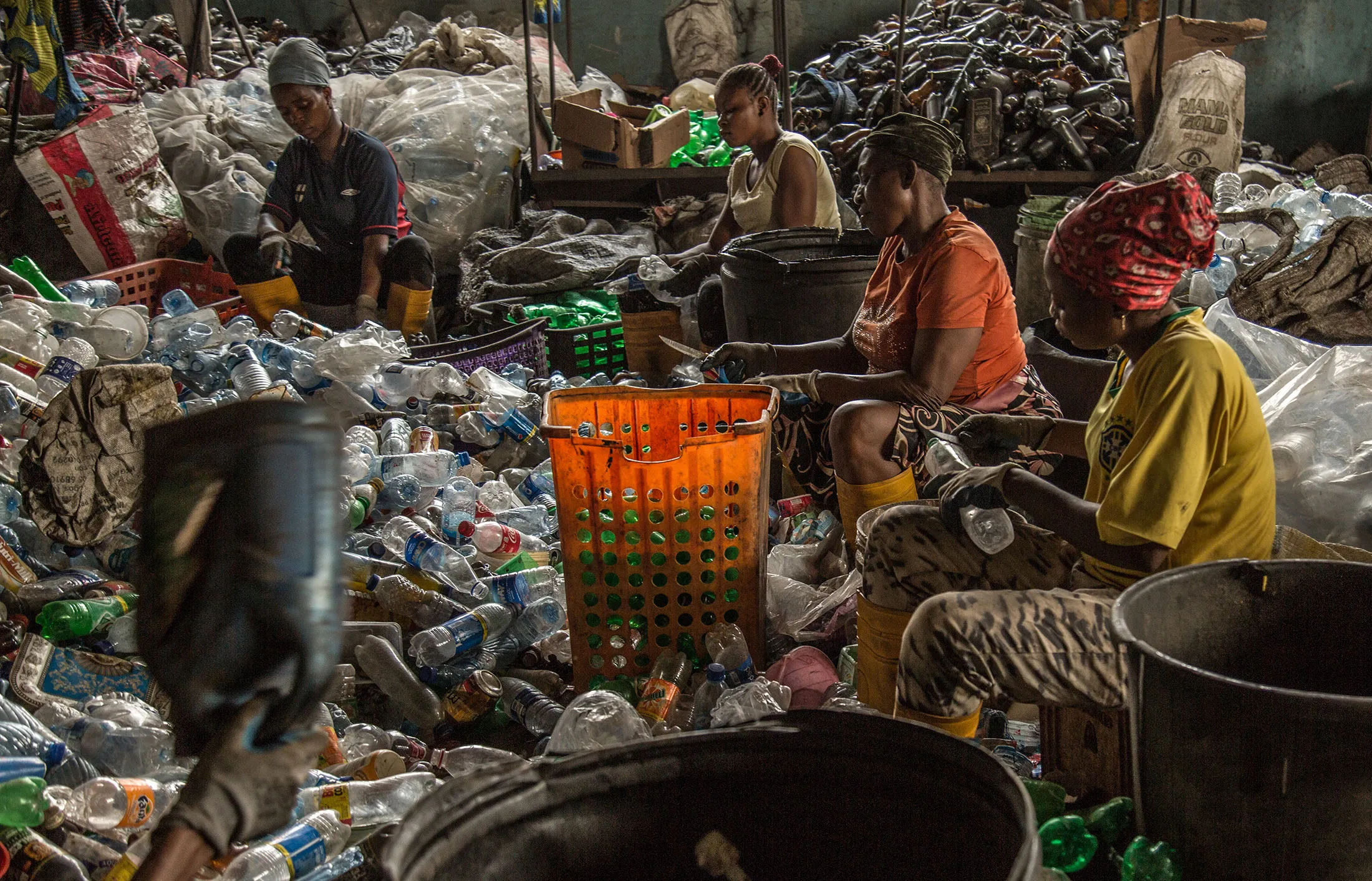 Women collect and sort bottles at Wecyclers’ recycling hub in Lagos.