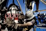 A Chesapeake Energy Corp. floorman, works on a Chesapeake natural gas rig in the North Texas Barnett Shale bed rock deposit near Kennendale, Texas, U.S.