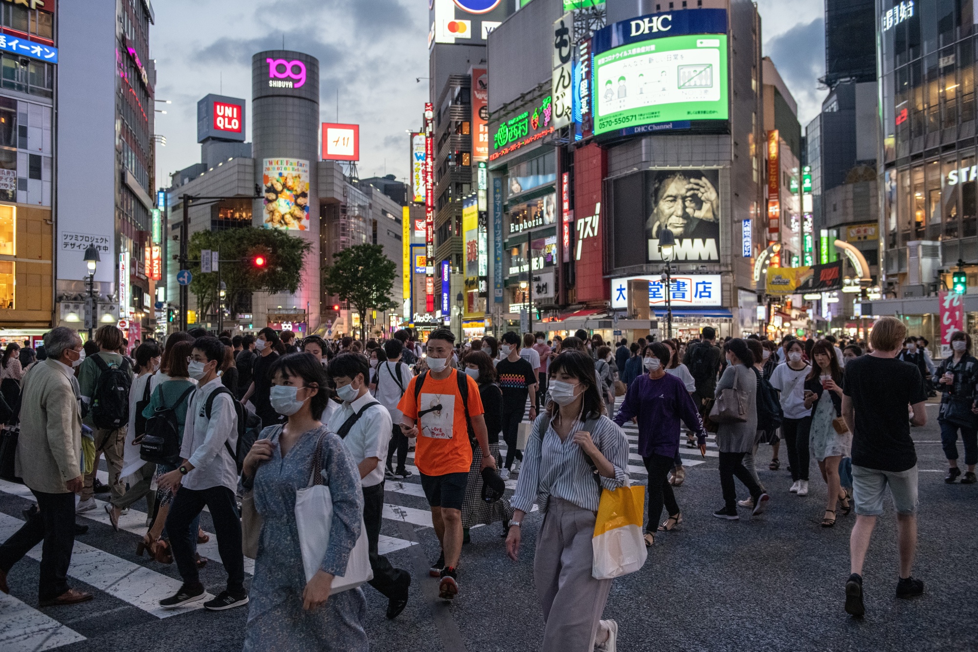 People in masks walk through Shibuya, Tokyo on June 23.