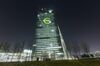 An illuminated euro currency symbol is projected on to the European Central Bank (ECB) headquarters during the Luminale light festival in Frankfurt, Germany.