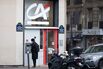 A customer uses an automated teller machine outside a Credit Agricole SA bank branch in Paris, France.