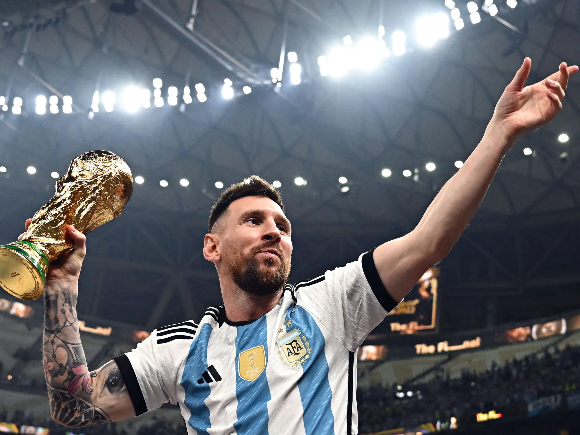 Lionel Messi holds the football World Cup trophy after Argentina’s victory in December 2022.