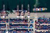 A tug boat pulls a container ship in the Busan Port Terminal (BPT) at the Port of Busan in this aerial photograph taken in Busan, South Korea, on Tuesday, July 30, 2019. A trade dispute between South Korea and Japan is threatening to spiral out of control, and both governments want the White House on their side.