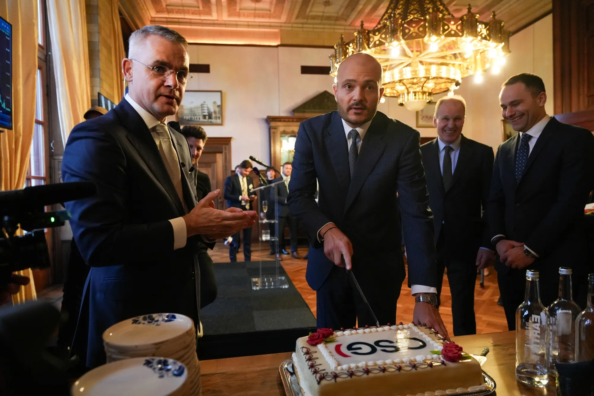 CSG Chairman Michal Strnad cuts a cake following the defense firm’s initial public offering in Amsterdam