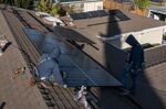 Contractors install SunRun solar panels on the roof of a home in San Jose, California.
