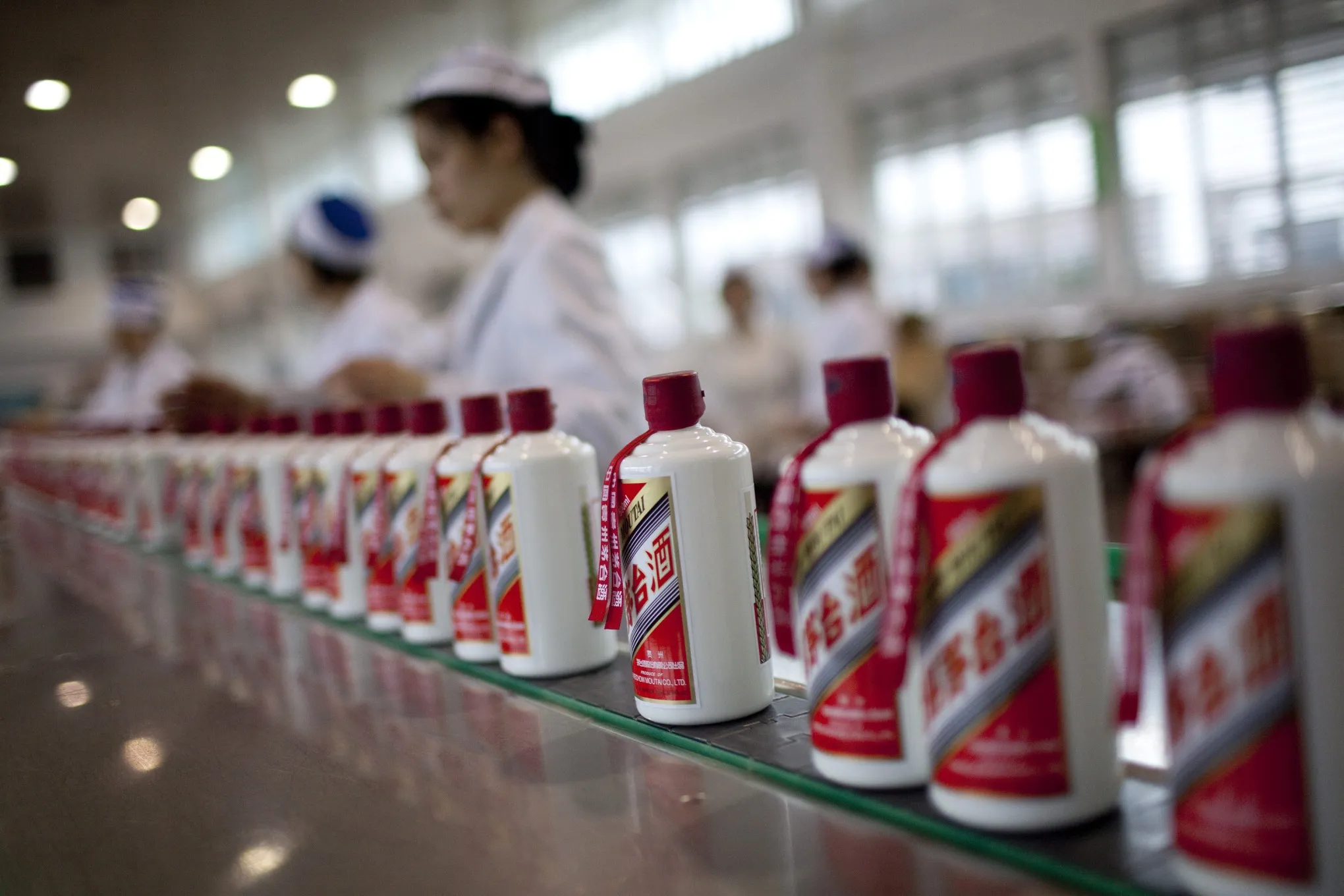 Workers package China Kweichow Moutai Distillery Co. baijiu liquor at the company's facility in the Maotai section of the Renhuai District in Zunyi, Guizhou Province, China, on Thursday, April 7, 2011.