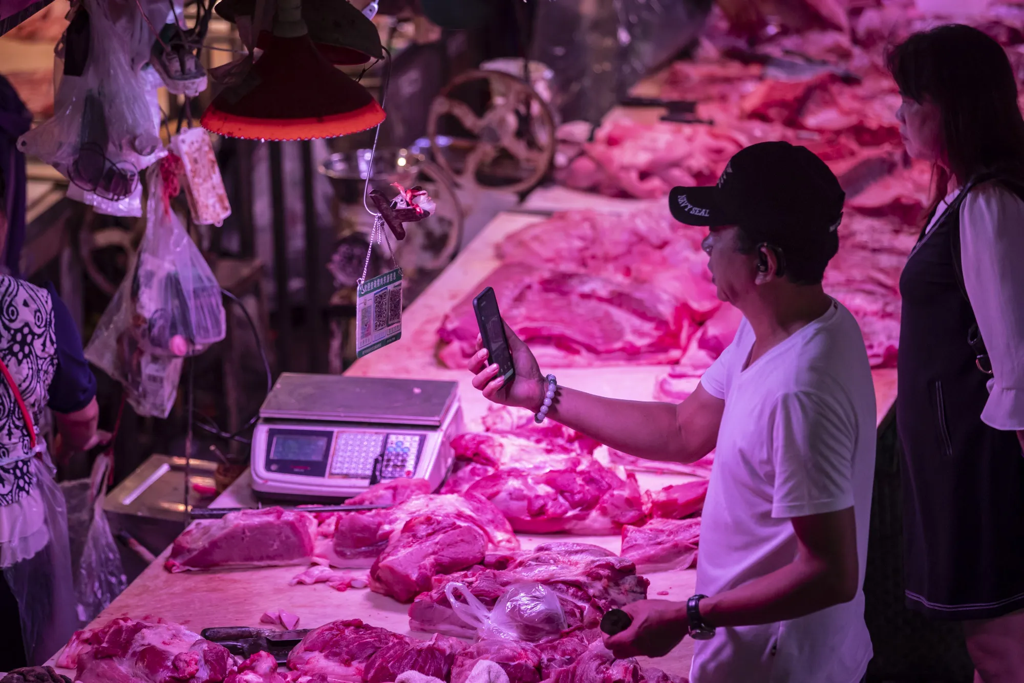 A customer uses his smartphone to scan a QR&nbsp;code for payment at a pork stall&nbsp;in Nanning, Guangxi province.