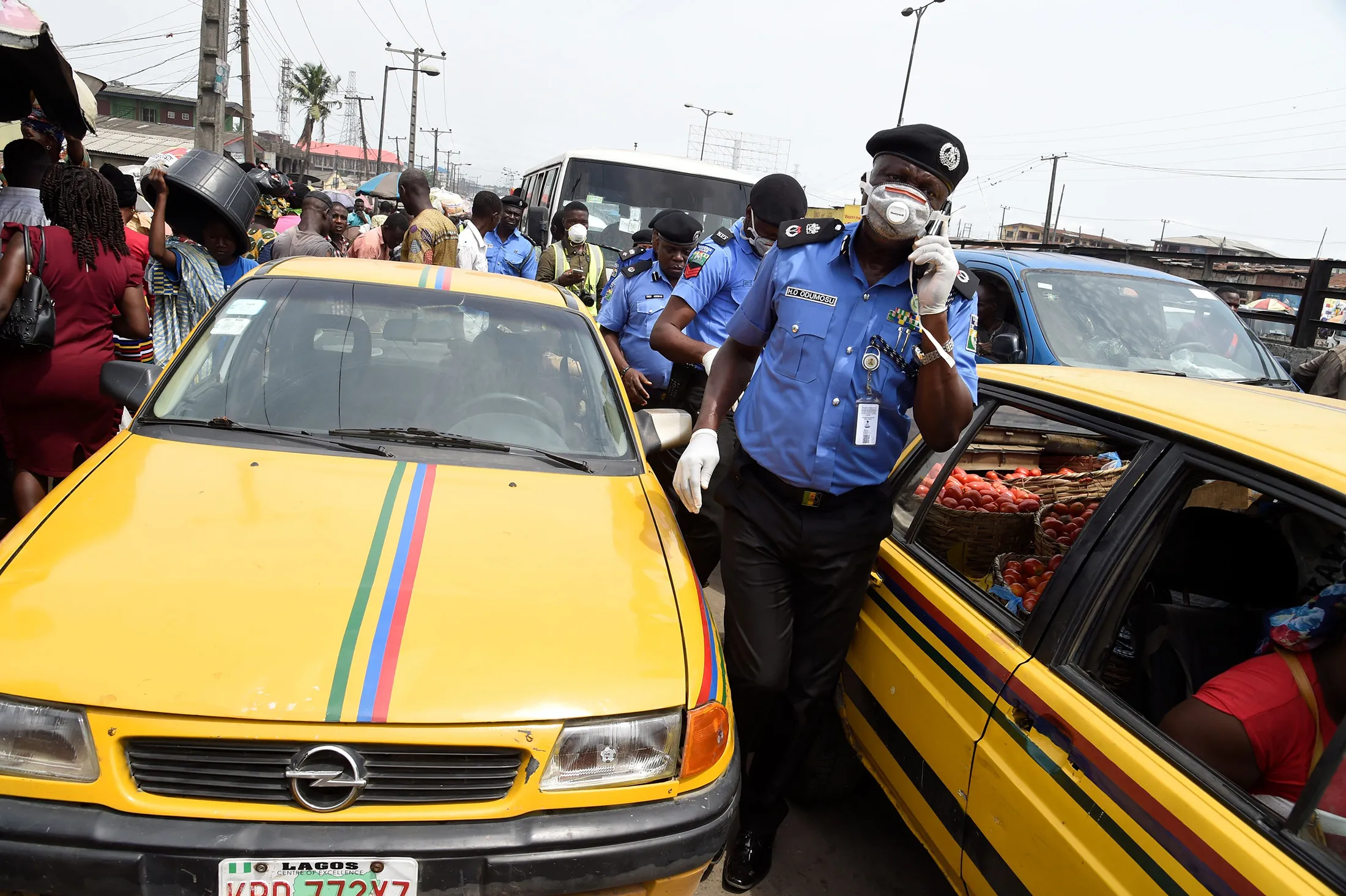 Hakeem Odumosu,&nbsp;Lagos Commissioner of Police, center, squeezes&nbsp;through a crowded market to monitor compliance measures to curb the spread of the&nbsp;coronavirus&nbsp;in Lagos on March 26.
