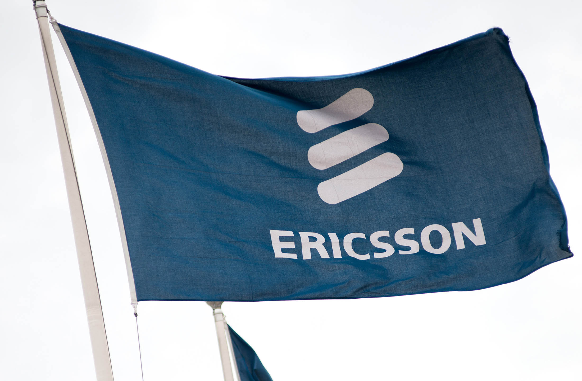 The Ericsson AB logo sits on a flag as it flies outside the company's data networking devices factory in Tallinn, Estonia.
