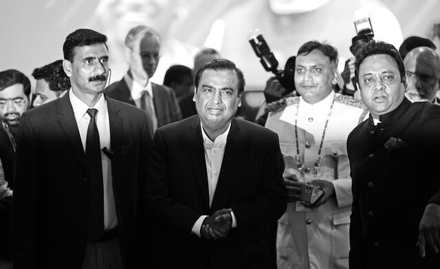 Mukesh Ambani stands in the middle of a press event in February