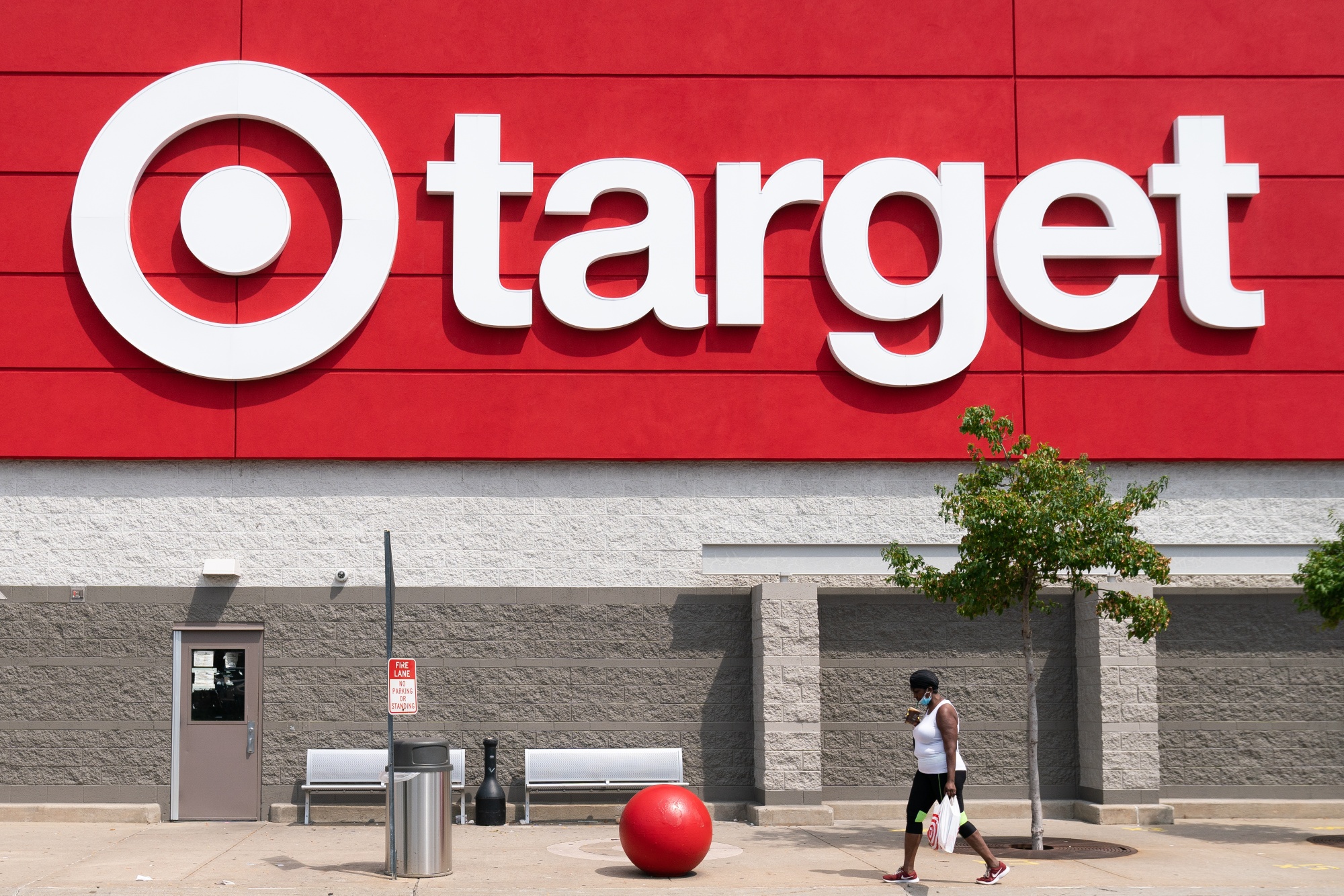 A shopper wearing a protective mask walks past a Target Corp. store in Jersey City, New Jersey.