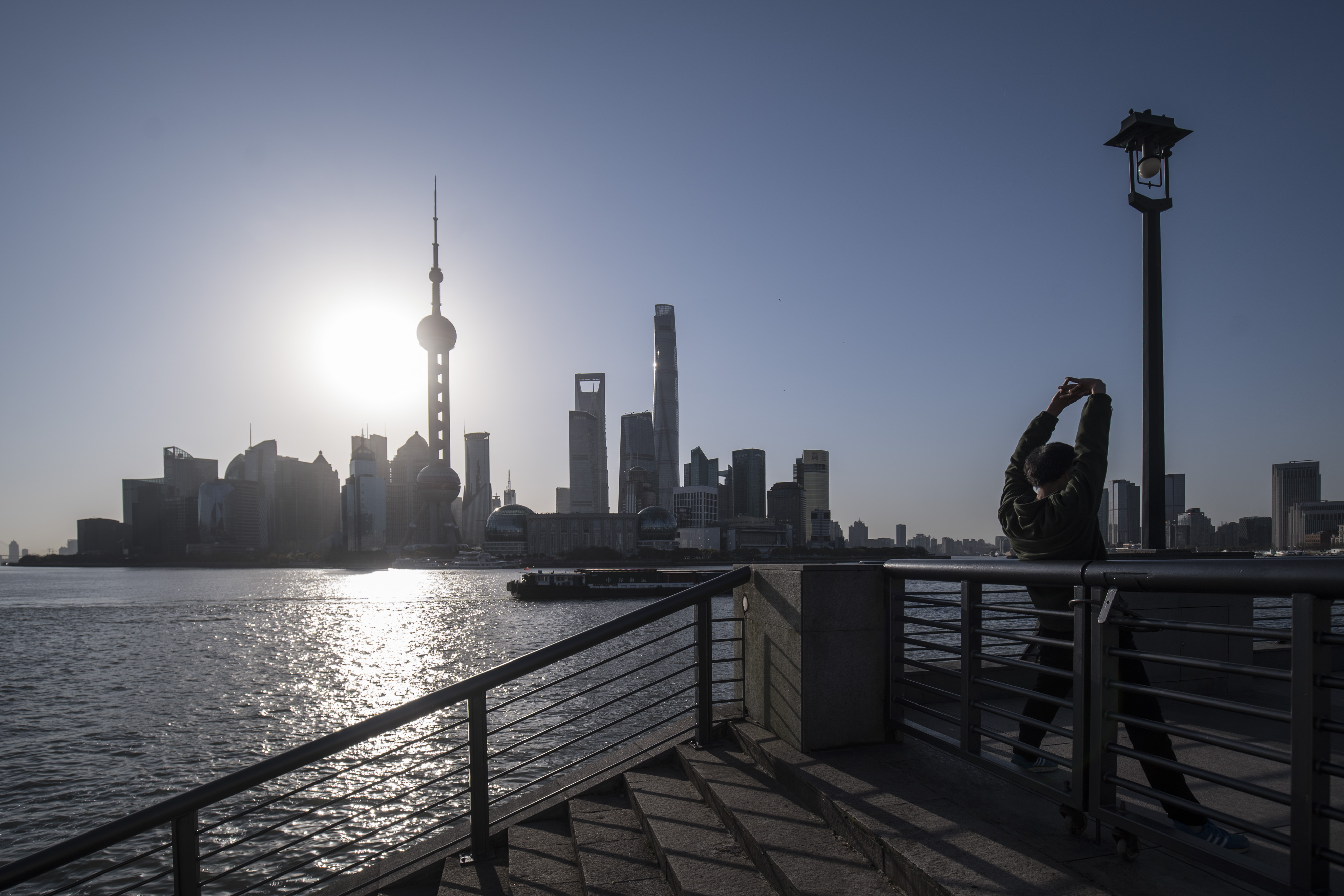 Office workers in Shanghai, as the prime minister says most of China is returning to normal