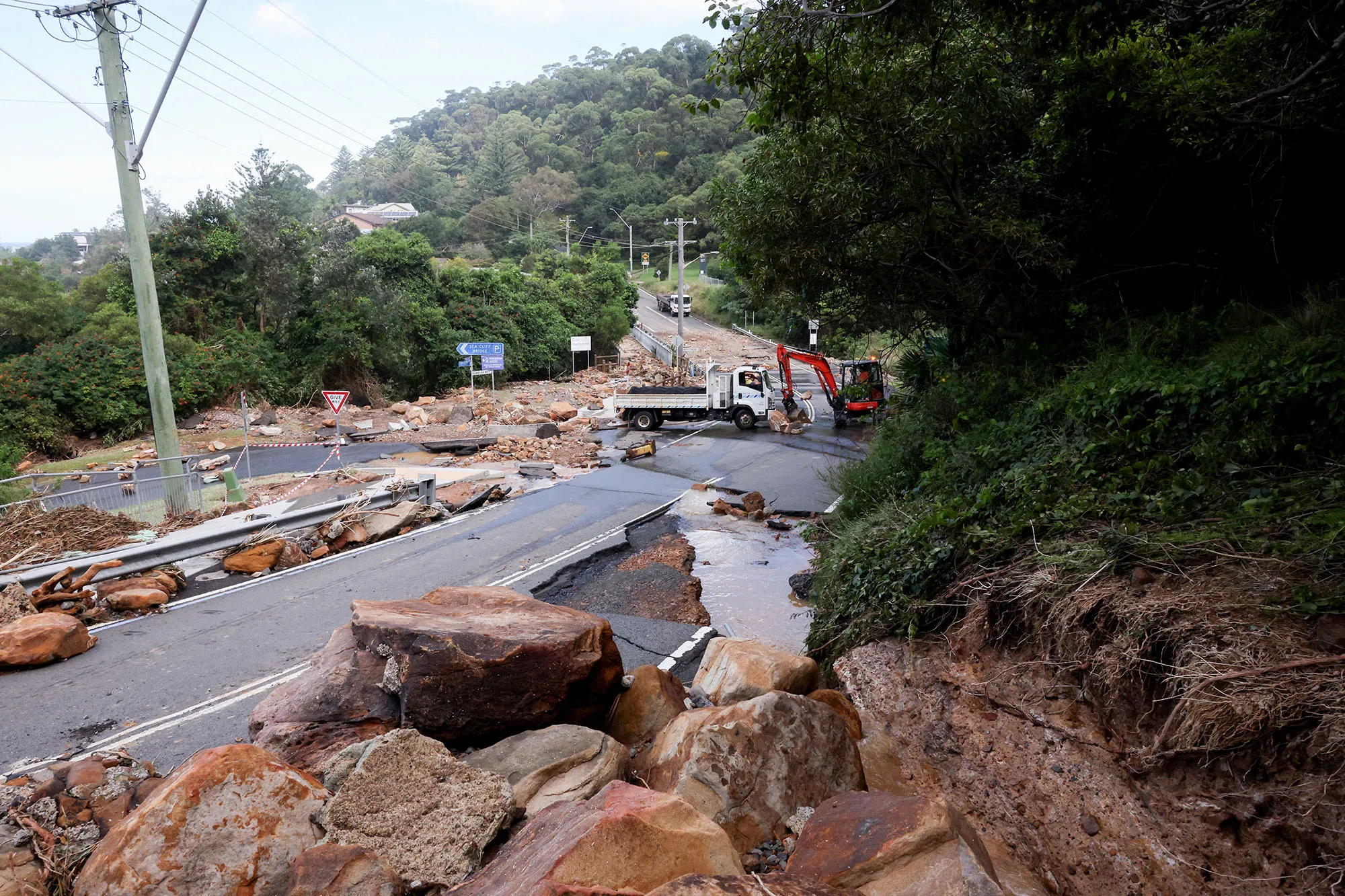 Workers clear boulders and rocks after a landslide due to heavy rain&nbsp;in&nbsp;Wollongong, Australia, on April 6.