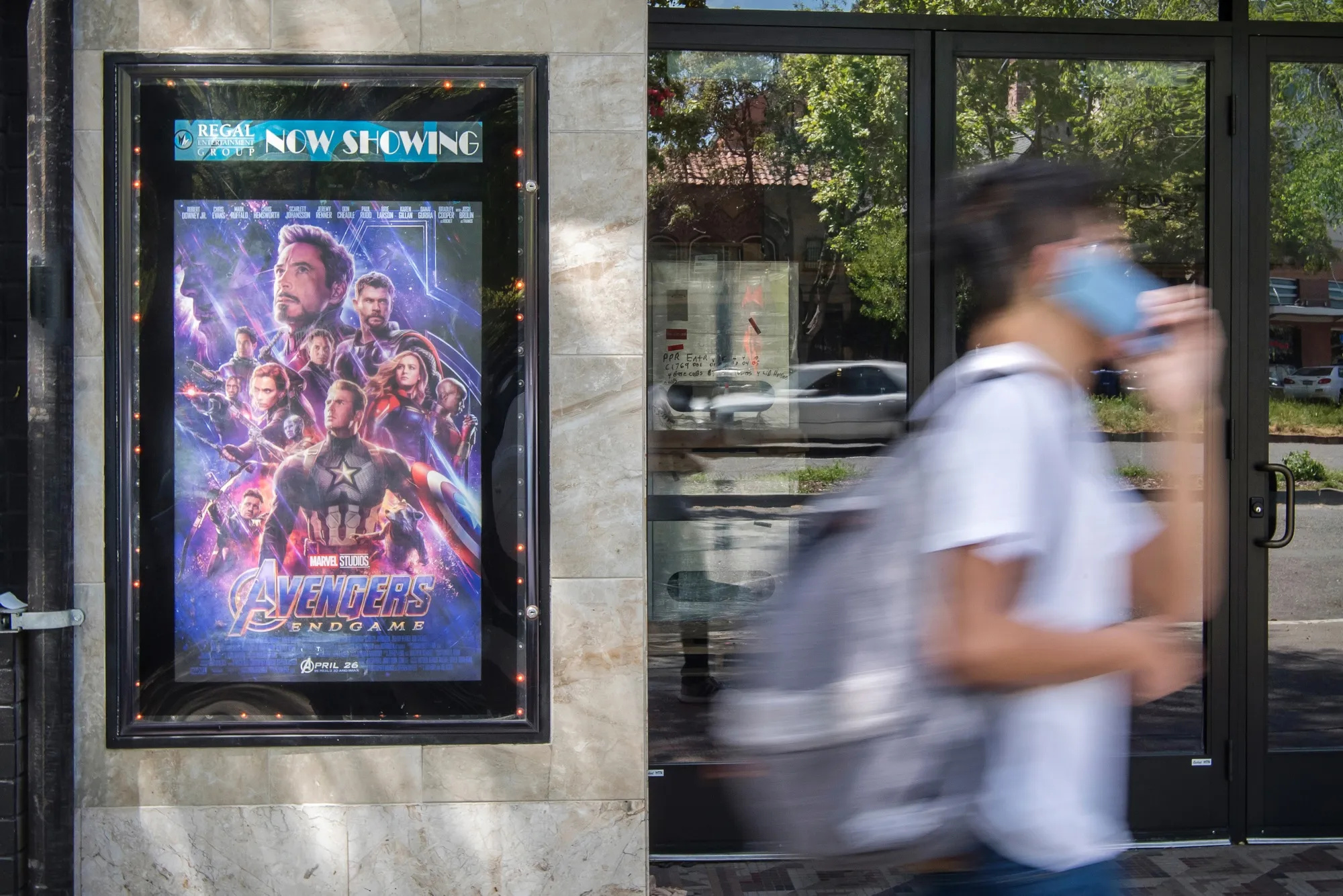 A pedestrian walks past an "Avengers: Endgame" poster in Berkeley, California.