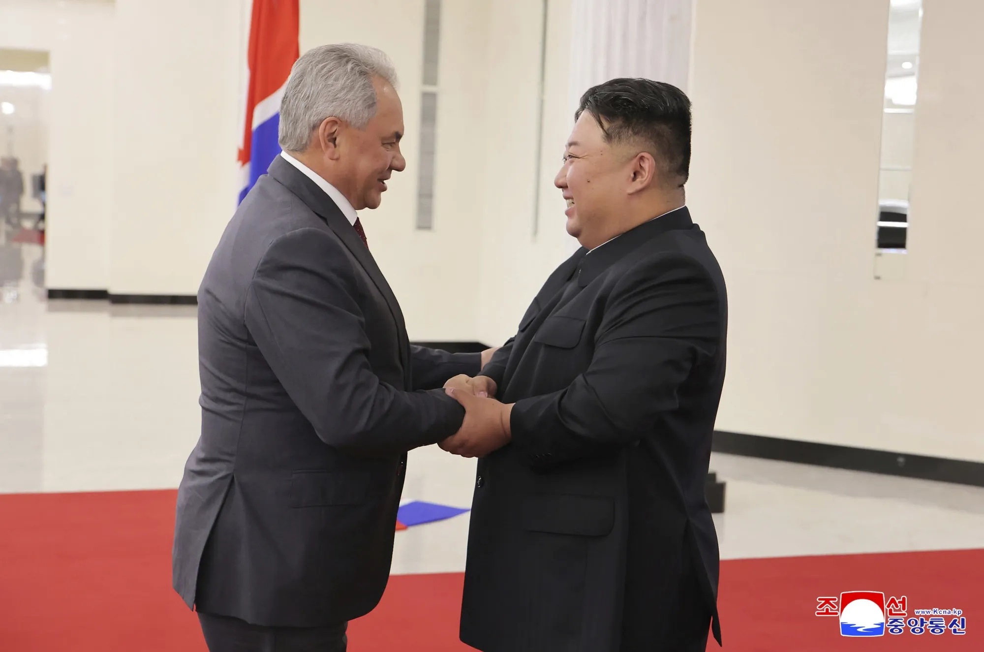 This photo by the North Korean government shows Sergei Shoigu, left, with Kim Jong Un in Pyongyang on June 17.
