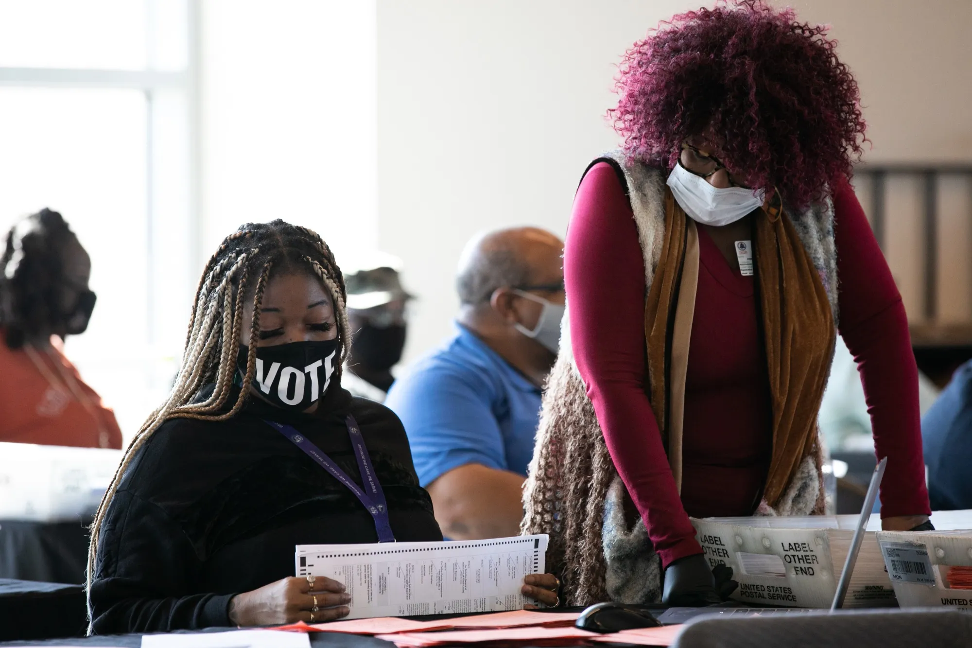 Fulton county workers count absentee ballots at State Farm Arena on November 6, 2020 in Atlanta, Georgia. Since that election, the state has imposed new restrictions on mail-in ballots.&nbsp;