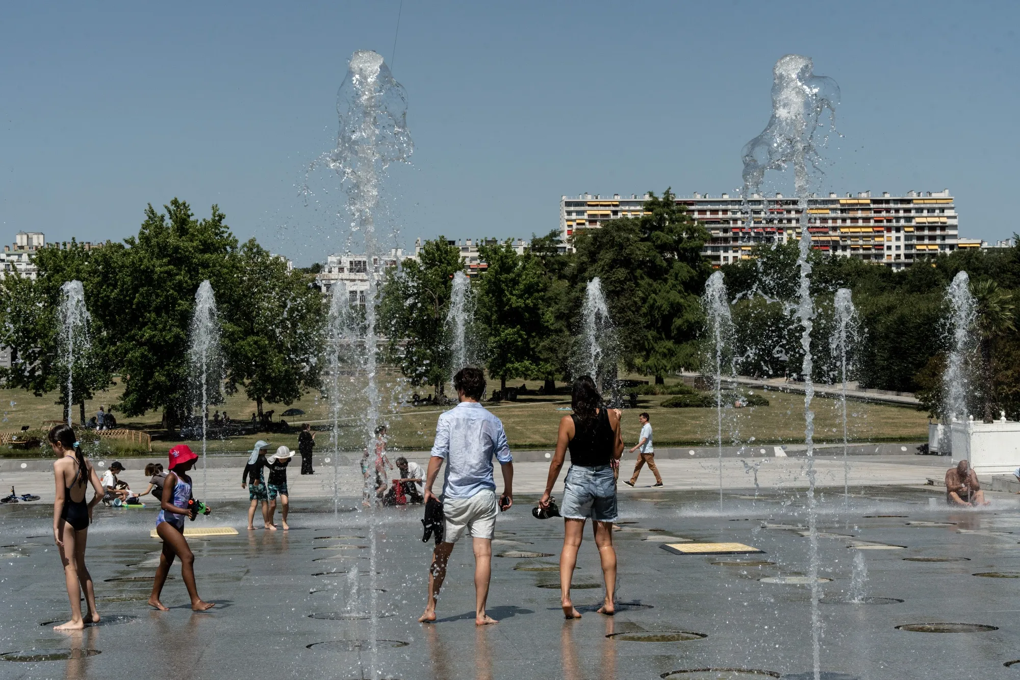 Residents try to keep cool in a fountain in the Parc Andre Citroenin Paris, France, on July 1.