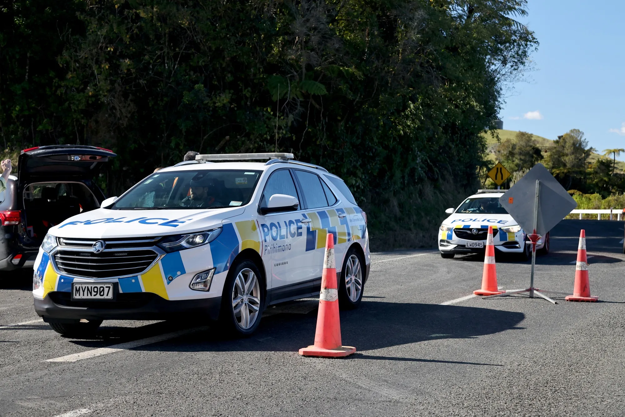 Police cars arrive at a roadblock where a police shootout occurred near the town of Piopio, in New Zealand's Waikato region on Sept. 8.