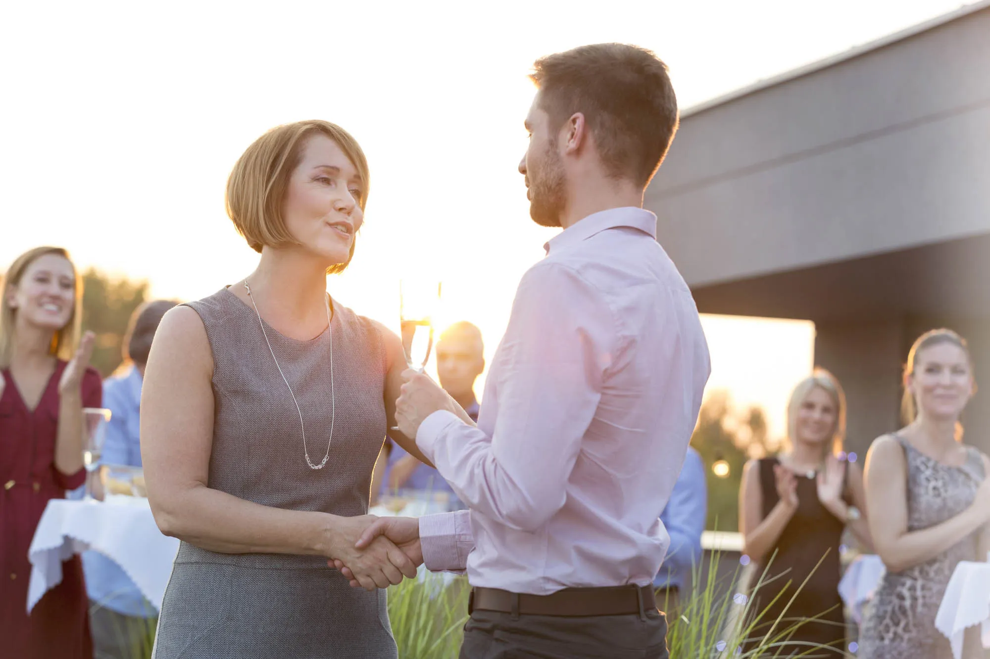 Businesswoman shaking hands with man on a company party