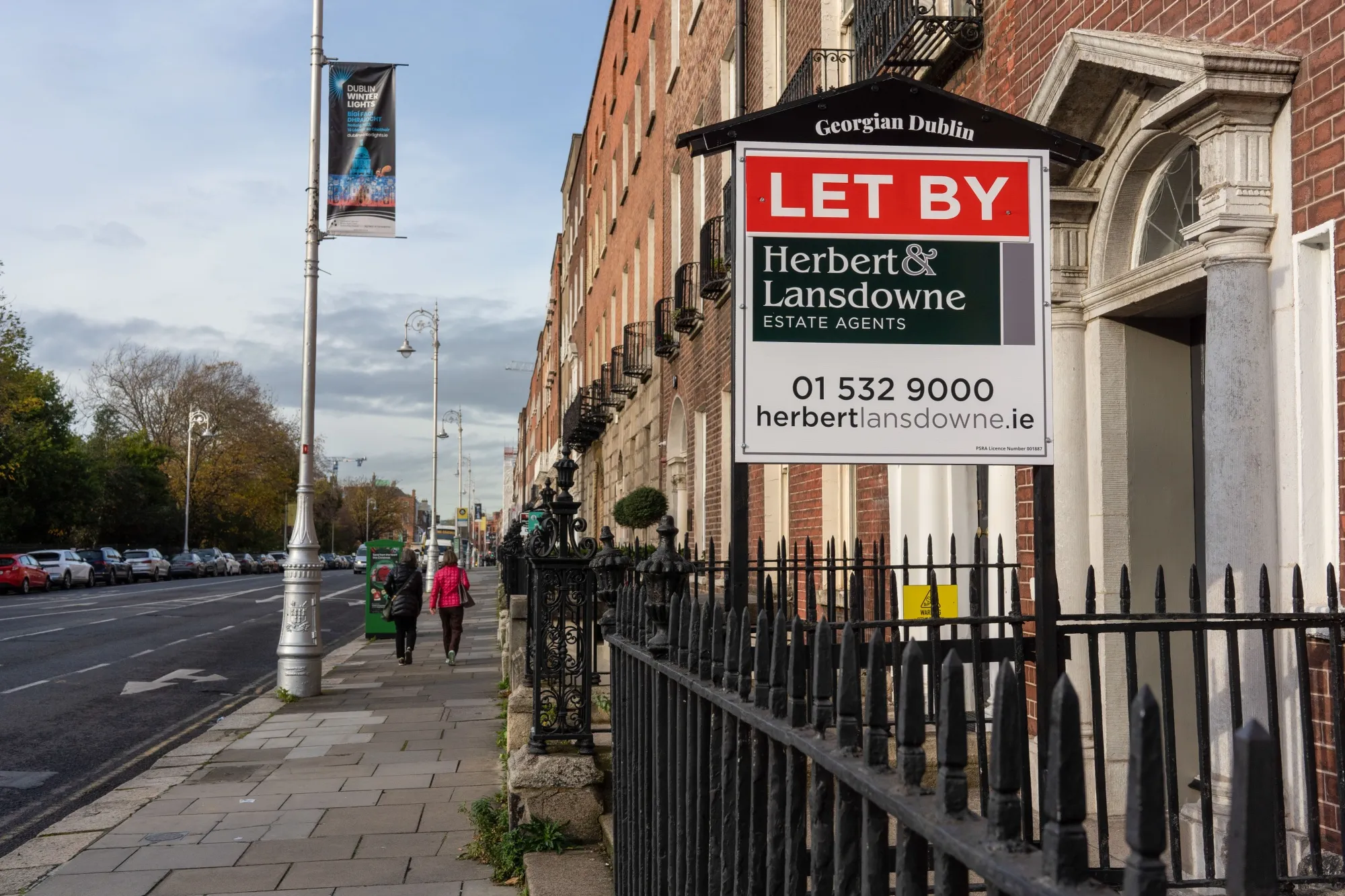 An estate agent's board outside housing in central Dublin.