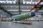The assembled fuselage of an Airbus A320 jet is wheeled from the factory floor in Hamburg.