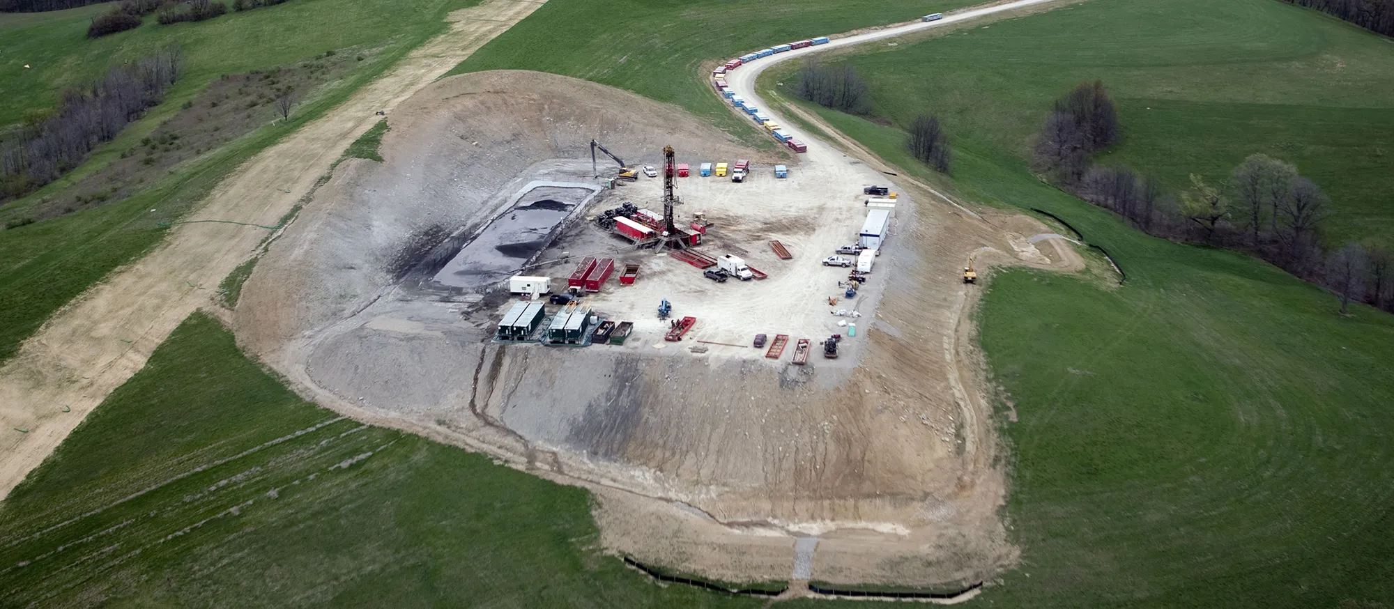 A vertical natural gas drilling rig and cutting impoundment is seen in Chartiers Township, Washington County, Pennsylvania.