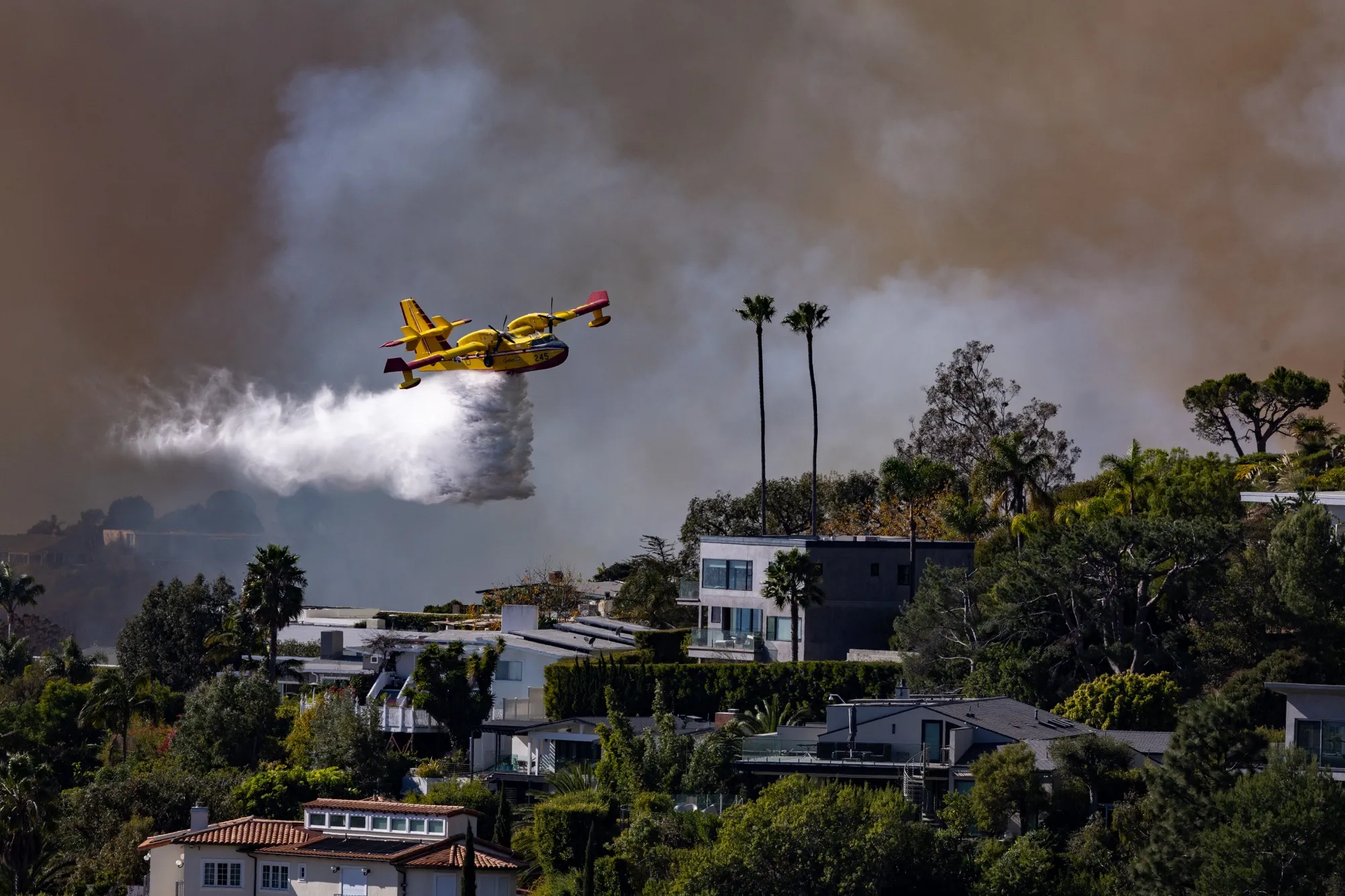 A plane drops water on the Palisades fire over&nbsp;Los Angeles County, California, on Jan. 7.&nbsp;