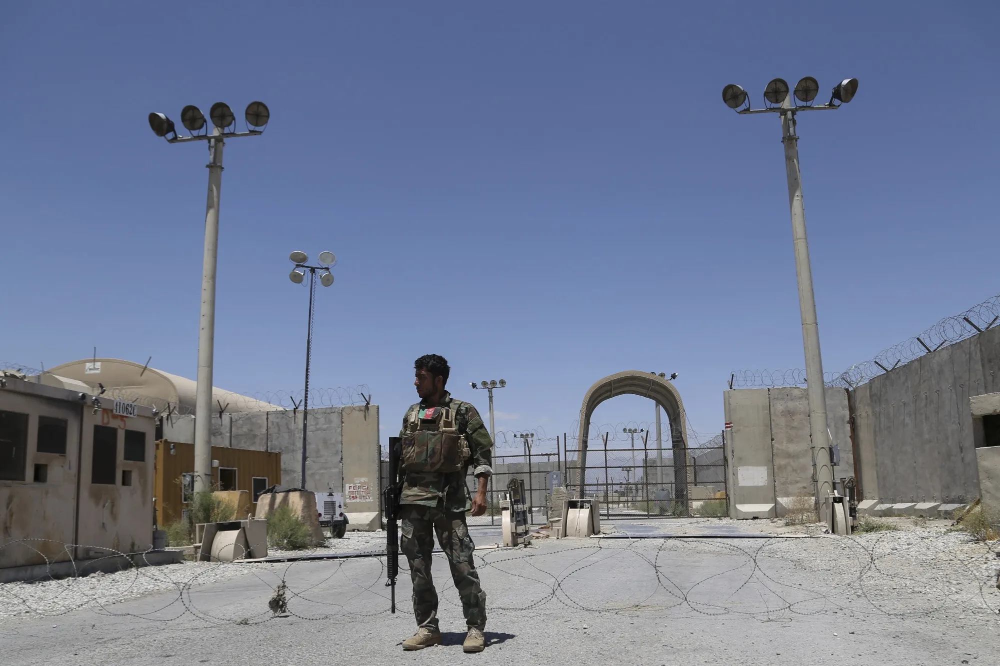 An Afghan National Army soldier stands guard at Bagram Air Base, north of Kabul on July 2,